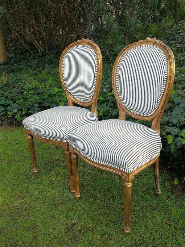 A 20th Century French Style Imported Set Of Twelve Gilded Dining Chairs Comprising: Two Carvers  ...