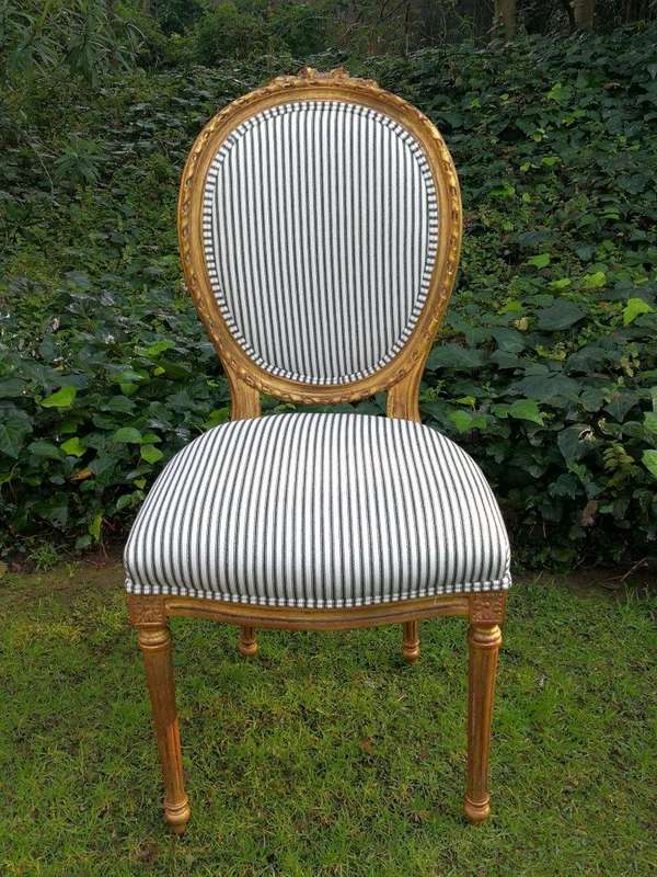 A 20th Century French Style Imported Set Of Twelve Gilded Dining Chairs Comprising: Two Carvers  ...