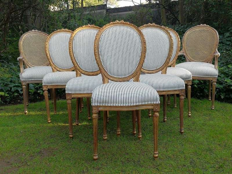 A 20th Century French Style Imported Set Of Twelve Gilded Dining Chairs Comprising: Two Carvers  ...