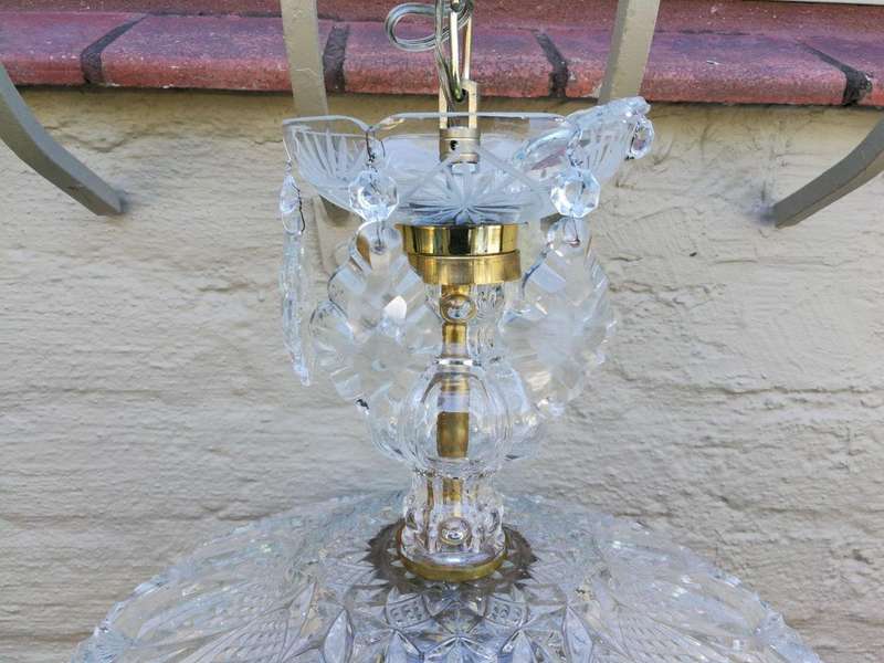 A French Style Brass and Crystal Plate Chandelier with Floral Top