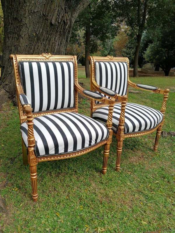 A Pair Of Louis XVI Style Carved And Gilded Armchairs