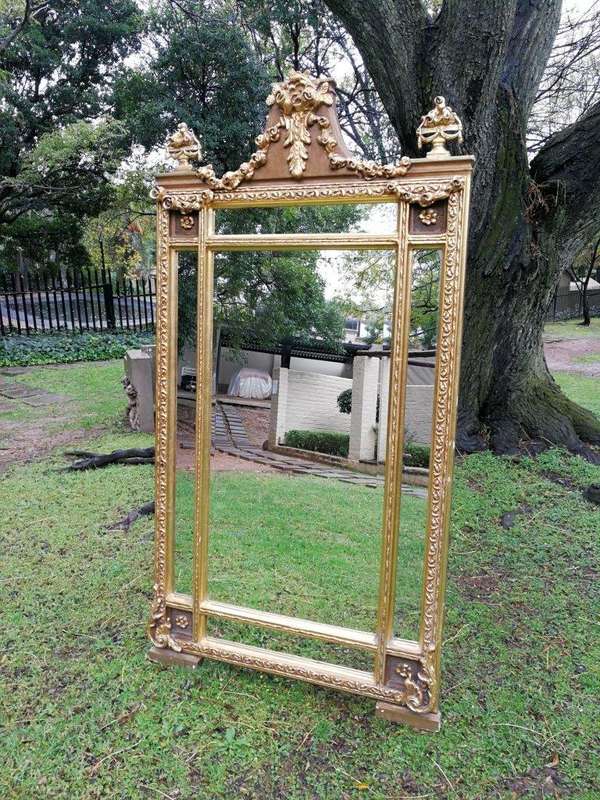 A French Style Ornately Carved and Gilded Bevelled Mirror