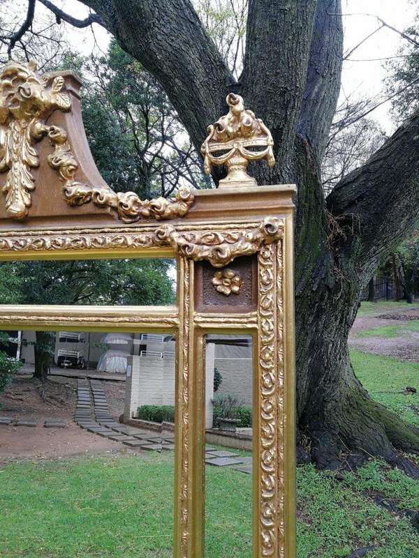 A French Style Ornately Carved and Gilded Bevelled Mirror