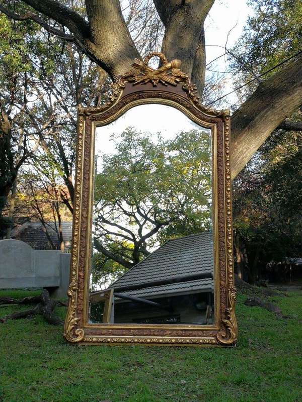 A French Rococo Style Ornately Carved and Gilded Bevelled Mirror