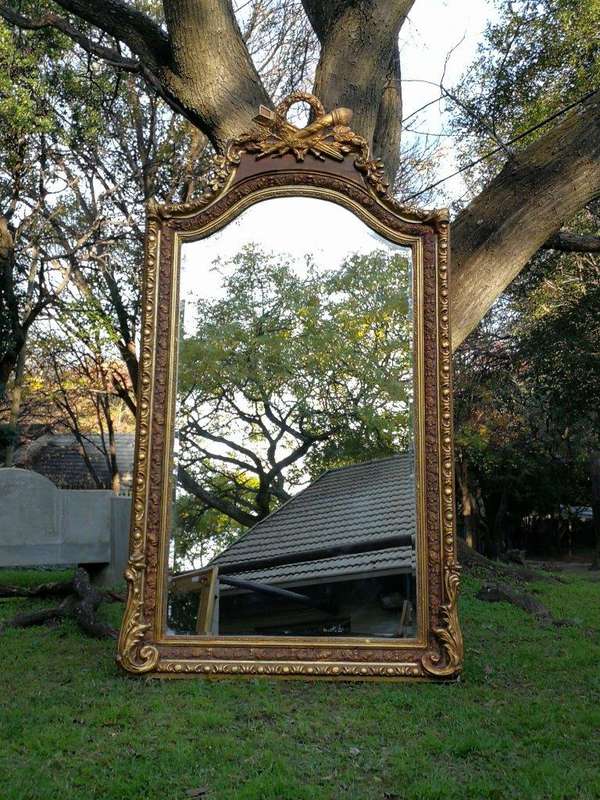 A French Rococo Style Ornately Carved and Gilded Bevelled Mirror