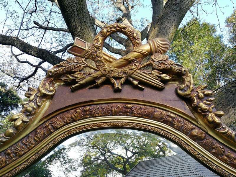 A French Rococo Style Ornately Carved and Gilded Bevelled Mirror