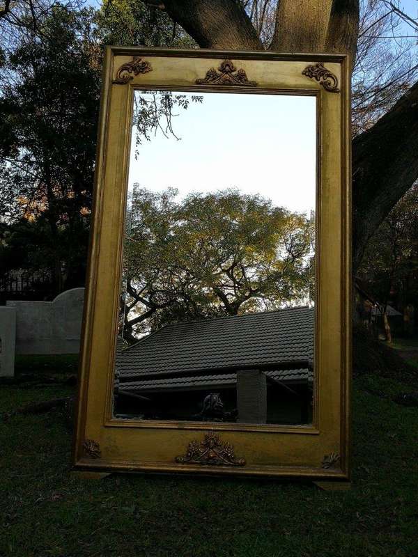 A French Style Ornately Carved and Gilded Bevelled Mirror