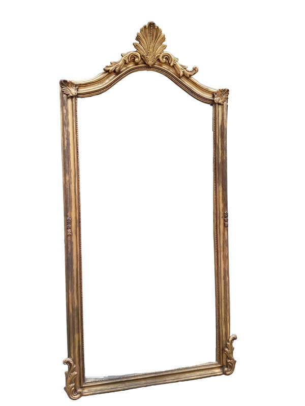 A French Style Ornately Carved And Gilded Bevelled Mirror
