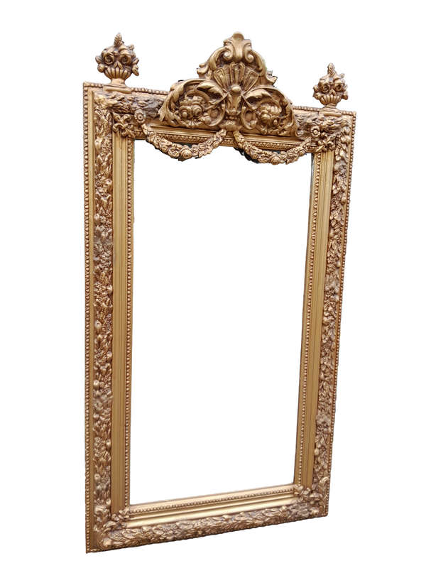 A French Style Ornately Carved And Gilded Bevelled Mirror