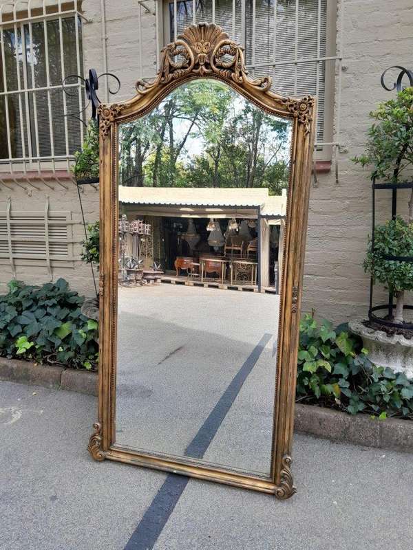 A French Style Rococo Ornately Carved And Gilded Bevelled Mirror