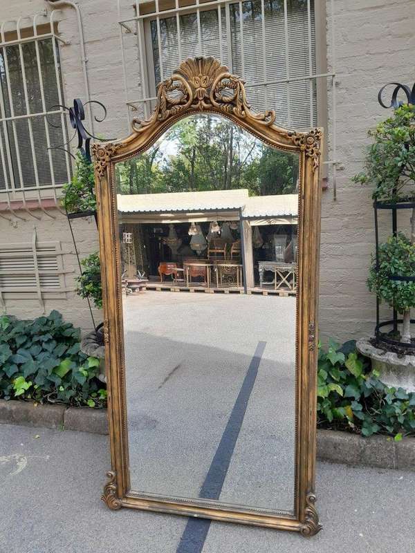 A French Style Rococo Ornately Carved And Gilded Bevelled Mirror