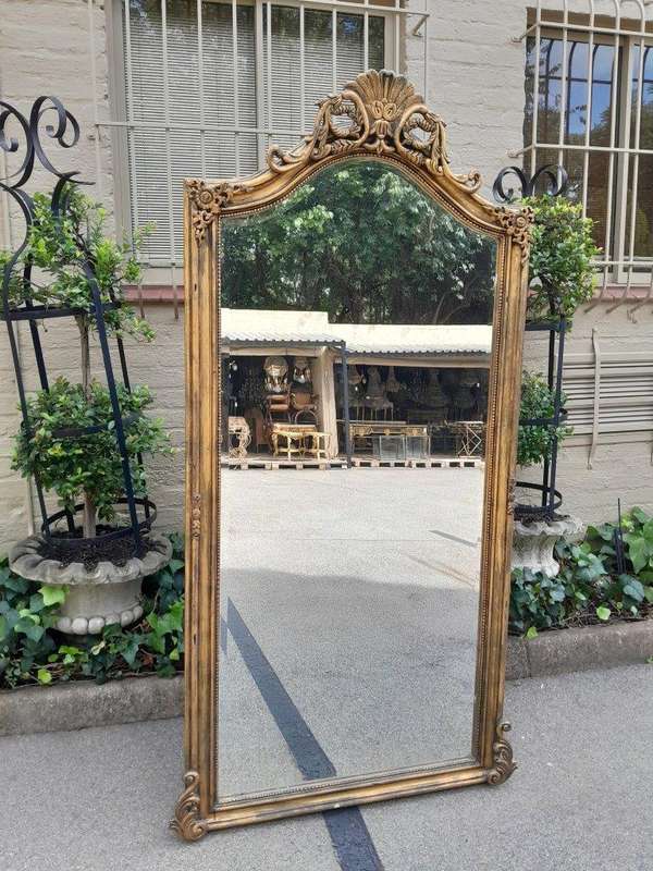 A French Style Rococo Ornately Carved And Gilded Bevelled Mirror