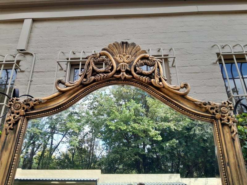 A French Style Rococo Ornately Carved And Gilded Bevelled Mirror