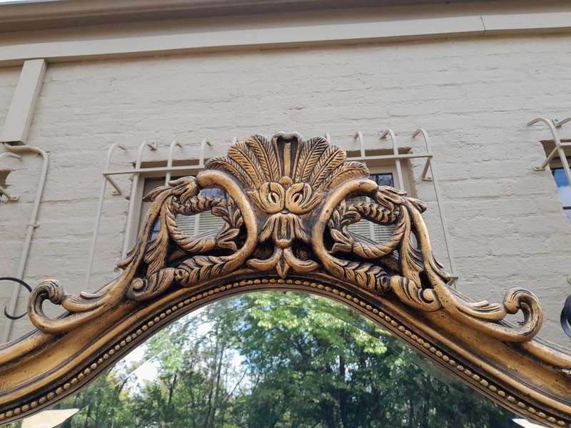 A French Style Rococo Ornately Carved And Gilded Bevelled Mirror