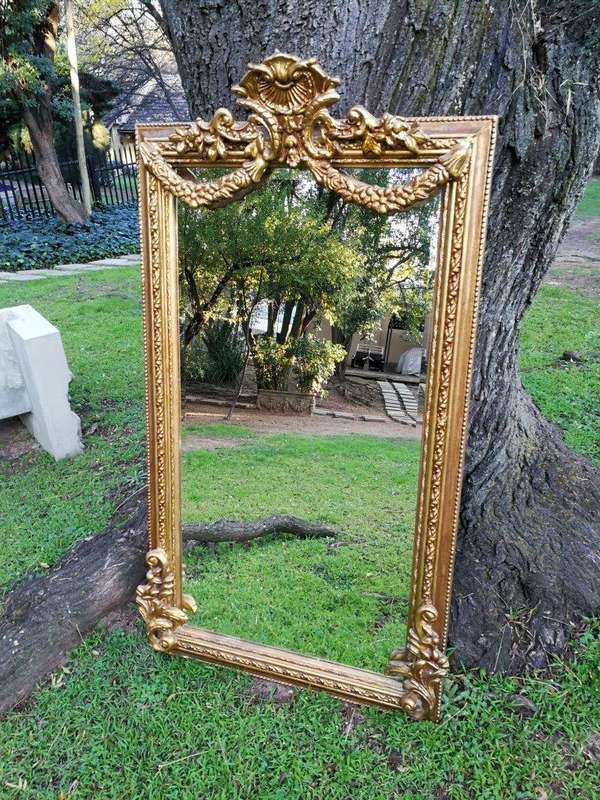 A French Style Ornately Carved and Gilded Bevelled Mirror