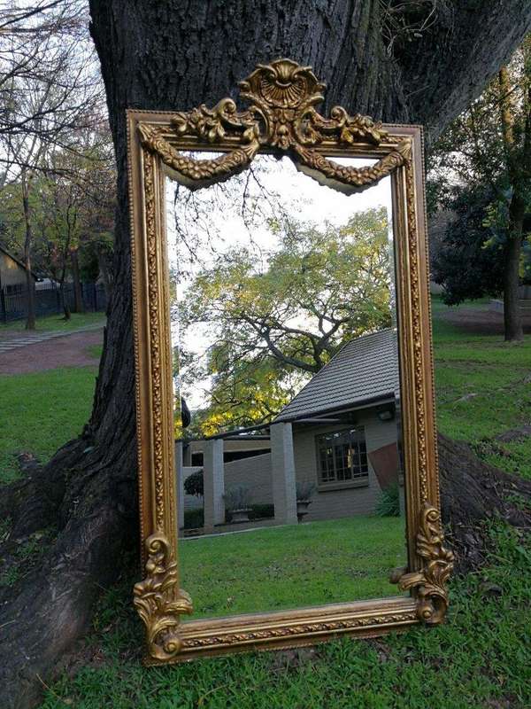 A French Style Ornately Carved and Gilded Bevelled Mirror