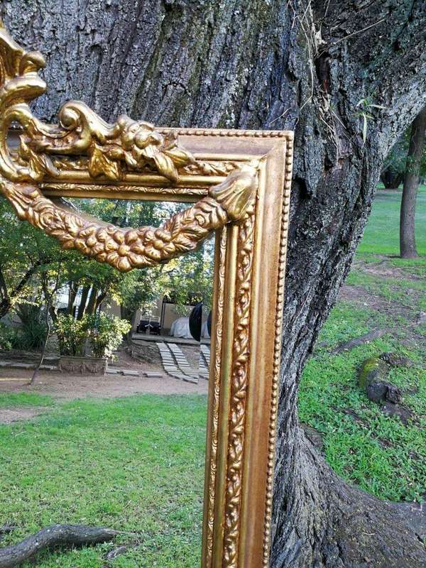 A French Style Ornately Carved and Gilded Bevelled Mirror