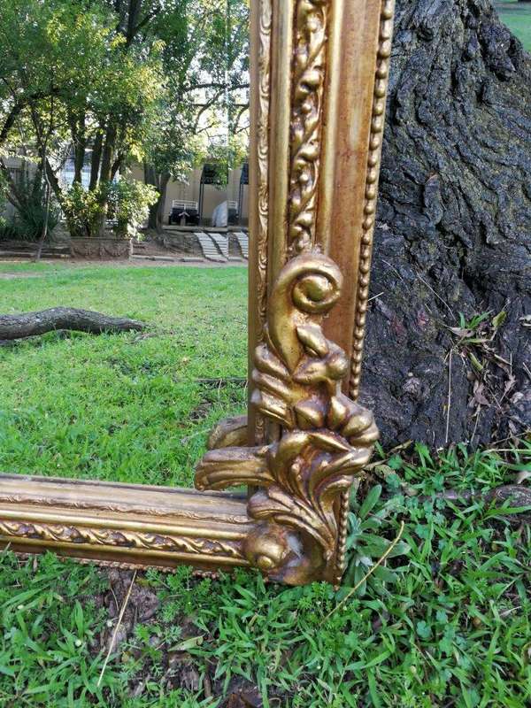 A French Style Ornately Carved and Gilded Bevelled Mirror