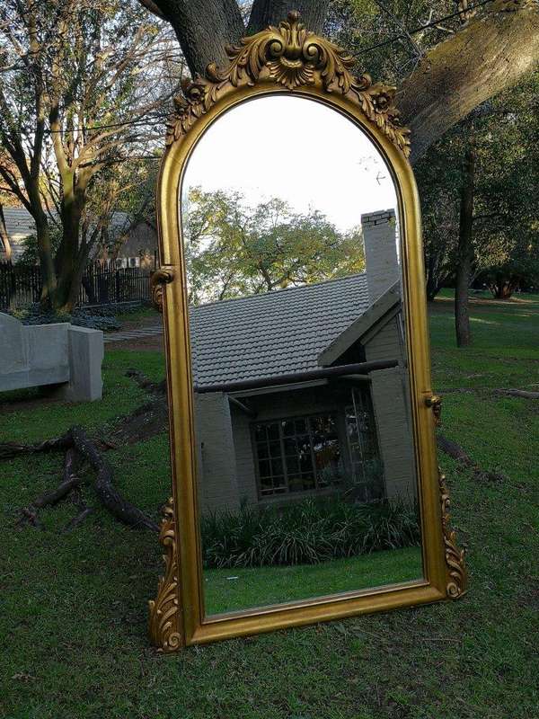 A French Style Ornately Carved Arched and Gilded Bevelled Mirror