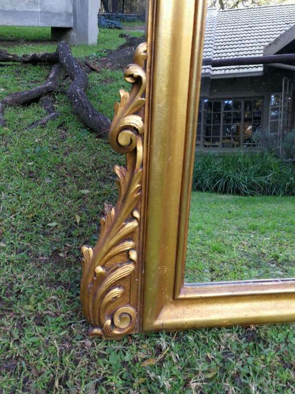 A French Style Ornately Carved Arched and Gilded Bevelled Mirror
