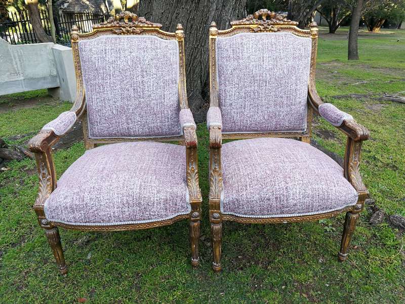 A Pair Of French Style Giltwood Ornate Arm Chairs On Fluted Legs