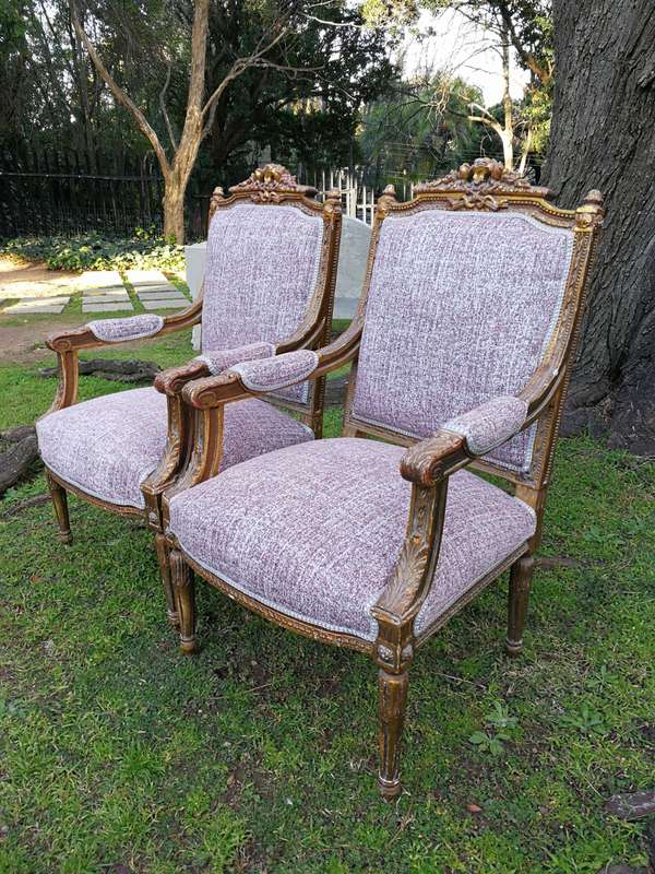 A Pair Of French Style Giltwood Ornate Arm Chairs On Fluted Legs