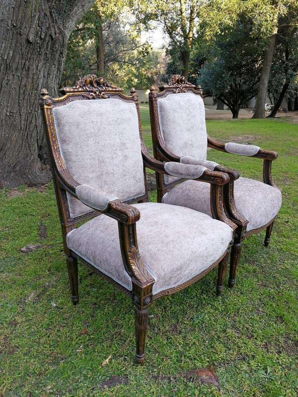 A Pair of French Style Giltwood Ornate Arm Chairs on Fluted legs 