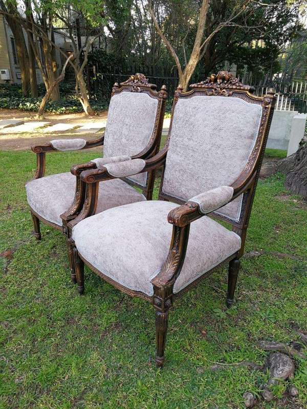 A Pair of French Style Giltwood Ornate Arm Chairs on Fluted legs 