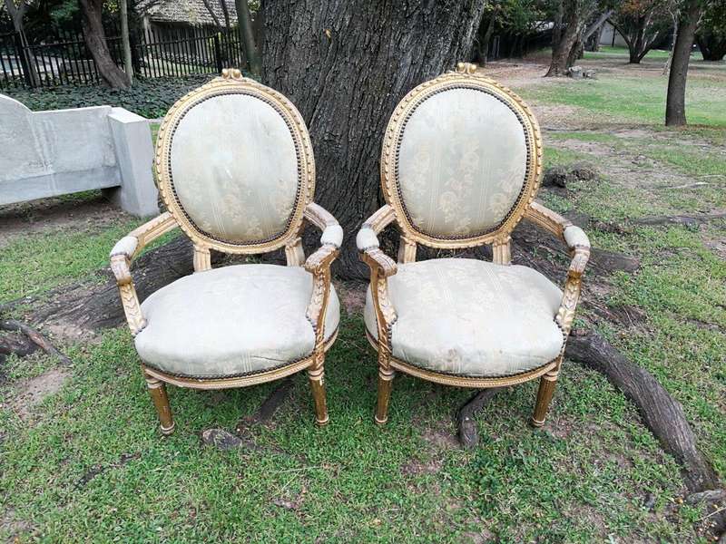 A Pair Of French Style Giltwood Ornate Arm Chairs On Fluted Legs 