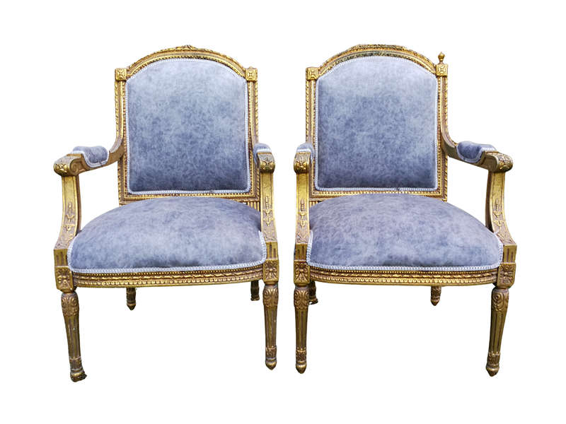 A Pair of French Style Giltwood Ornate Arm Chairs on Fluted legs 
