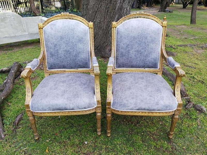 A Pair of French Style Giltwood Ornate Arm Chairs on Fluted legs 
