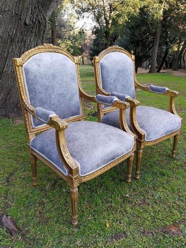 A Pair of French Style Giltwood Ornate Arm Chairs on Fluted legs 