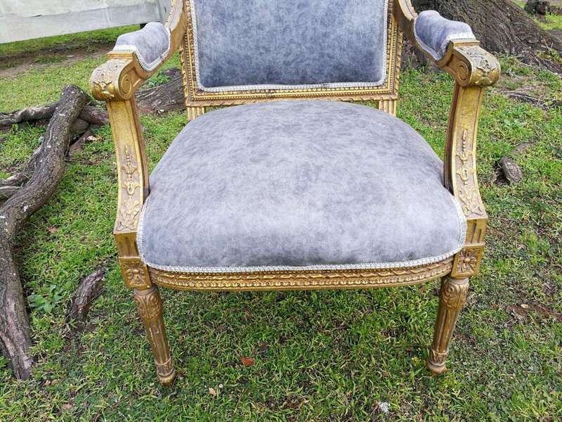 A Pair of French Style Giltwood Ornate Arm Chairs on Fluted legs 