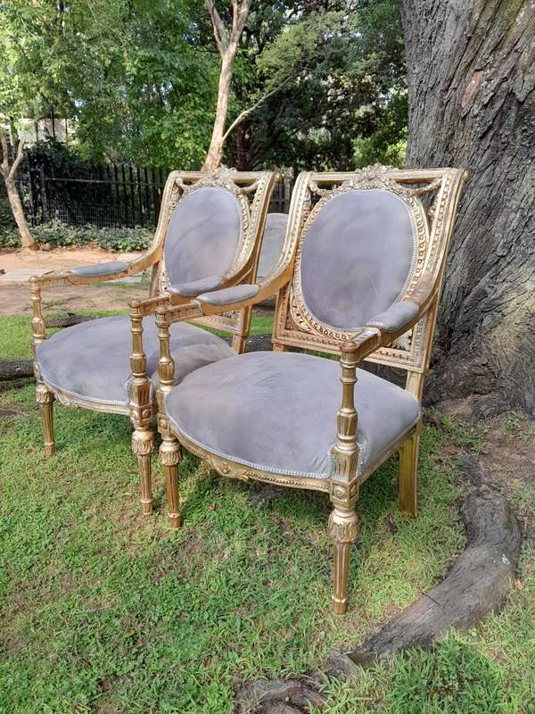 A Set of Eight French Style Ornately Carved and Gilded Dining Chairs (6 chairs and 2 Carvers)