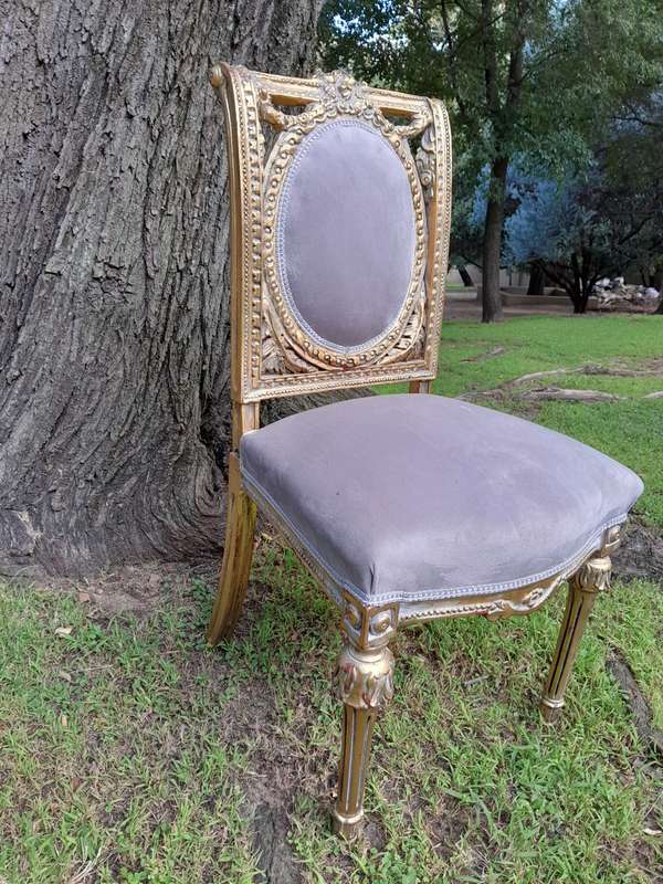 A Set of Eight French Style Ornately Carved and Gilded Dining Chairs (6 chairs and 2 Carvers)