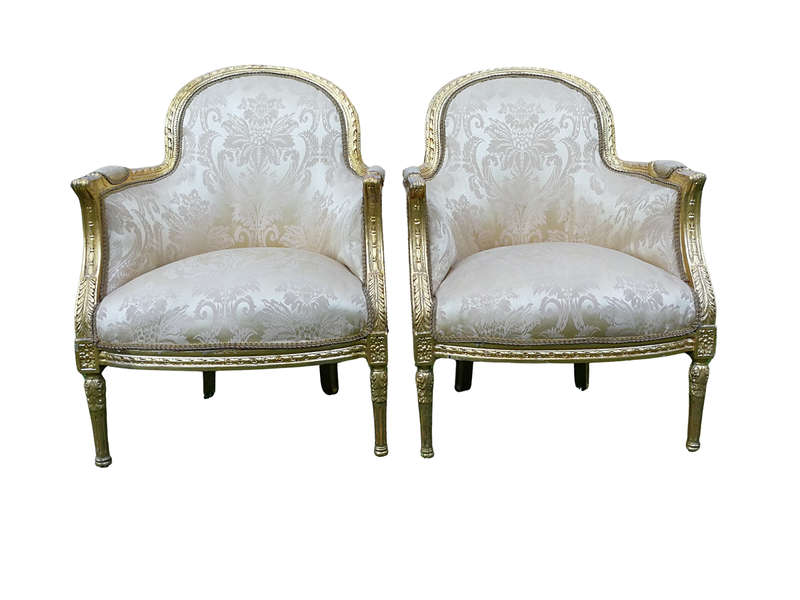 A Pair of French Louis XVI  Style Ornately Carved and Gilded Armchairs