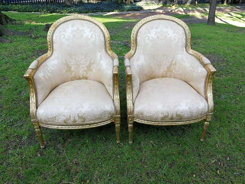 A Pair of French Louis XVI  Style Ornately Carved and Gilded Armchairs