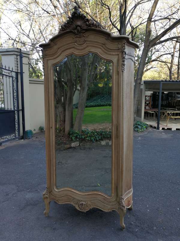 An Early 20th Century French-Style Carved Mahogany And Bevelled Mirrored Armoire in a Contemporar...