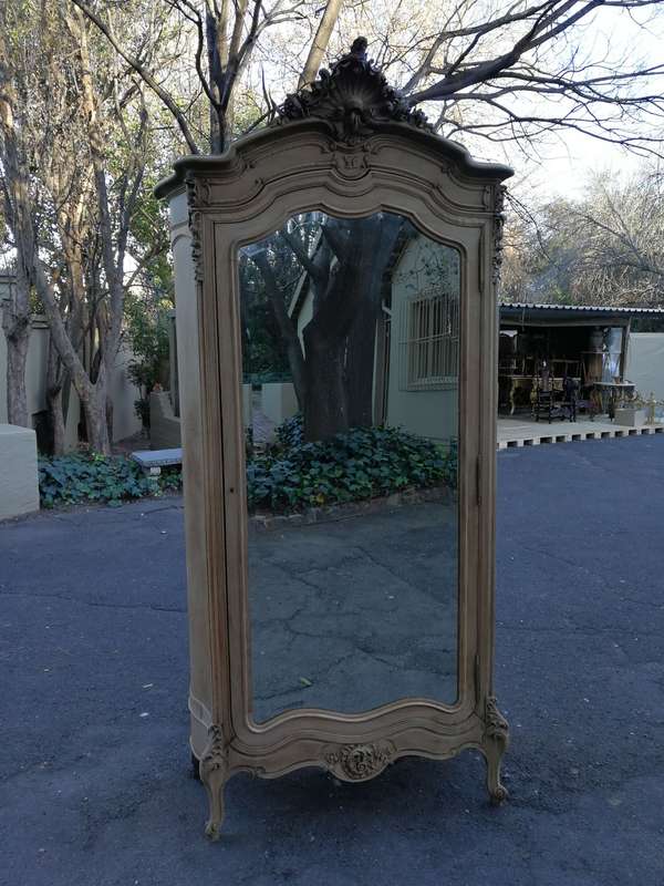 An Early 20th Century French-Style Carved Mahogany And Bevelled Mirrored Armoire in a Contemporar...