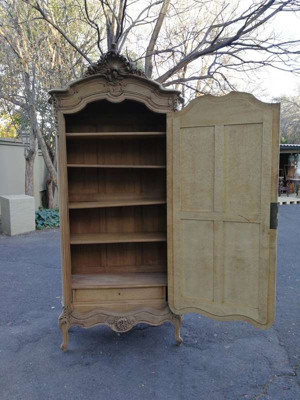 An Early 20th Century French-Style Carved Mahogany And Bevelled Mirrored Armoire in a Contemporar...