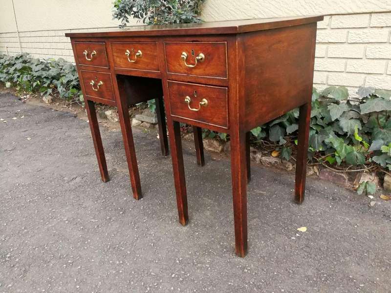 An 18th Century Oak Lowboy, With Brass Escutcheons And Loop Handles