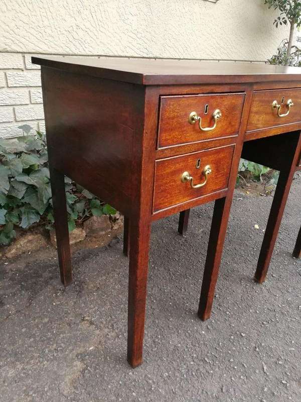 An 18th Century Oak Lowboy, With Brass Escutcheons And Loop Handles