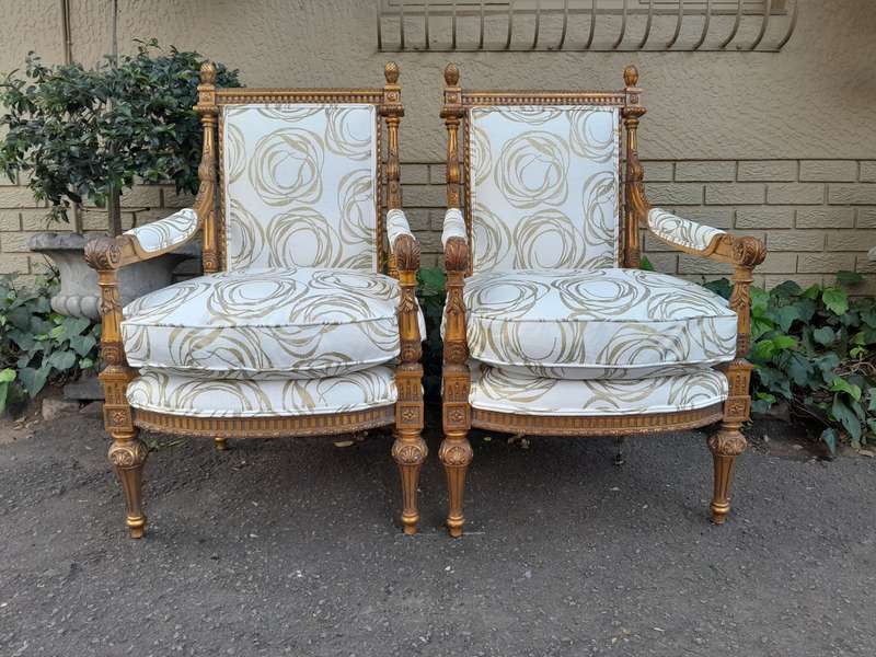 A Pair Of 20th Century Carved Wooden And Gilt-Painted Armchairs