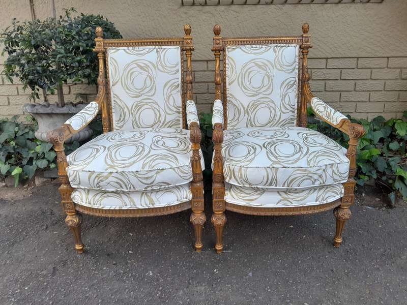 A Pair Of 20th Century Carved Wooden And Gilt-Painted Armchairs
