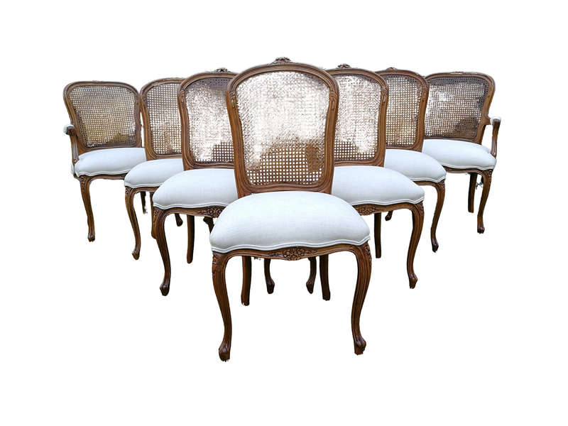 A 20th Century French Set Of Ten Walnut And Rattan Dining Chairs Consisting Of Two Carvers And Ei...