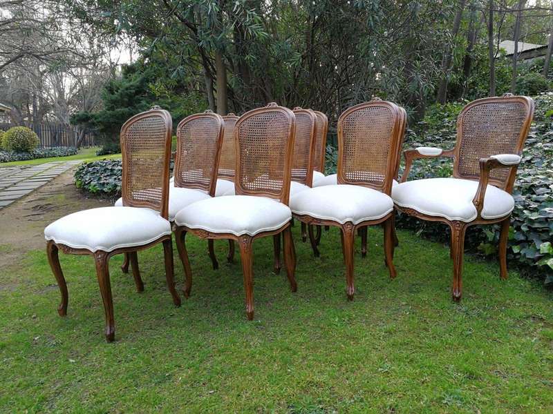 A 20th Century French Set Of Ten Walnut And Rattan Dining Chairs Consisting Of Two Carvers And Ei...