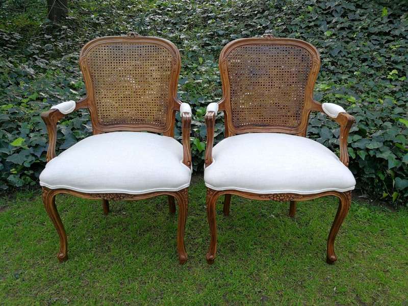 A 20th Century French Set Of Ten Walnut And Rattan Dining Chairs Consisting Of Two Carvers And Ei...