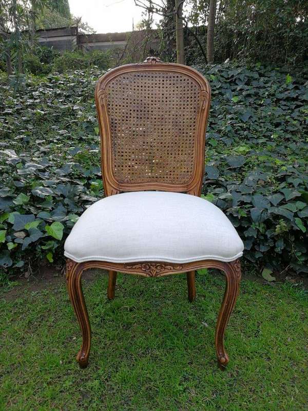 A 20th Century French Set Of Ten Walnut And Rattan Dining Chairs Consisting Of Two Carvers And Ei...