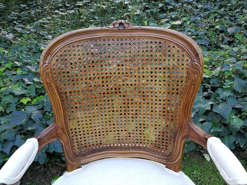 A 20th Century French Set Of Ten Walnut And Rattan Dining Chairs Consisting Of Two Carvers And Ei...