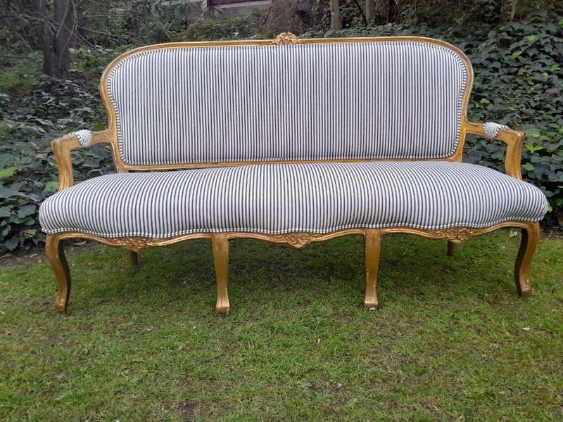 A 20TH Century French-style Carved and Giltwood Settee and a Pair of Armchairs upholsterd in a Co...